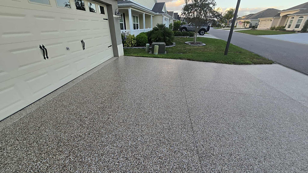 Driveway with dark gray flake epoxy coating, no cars